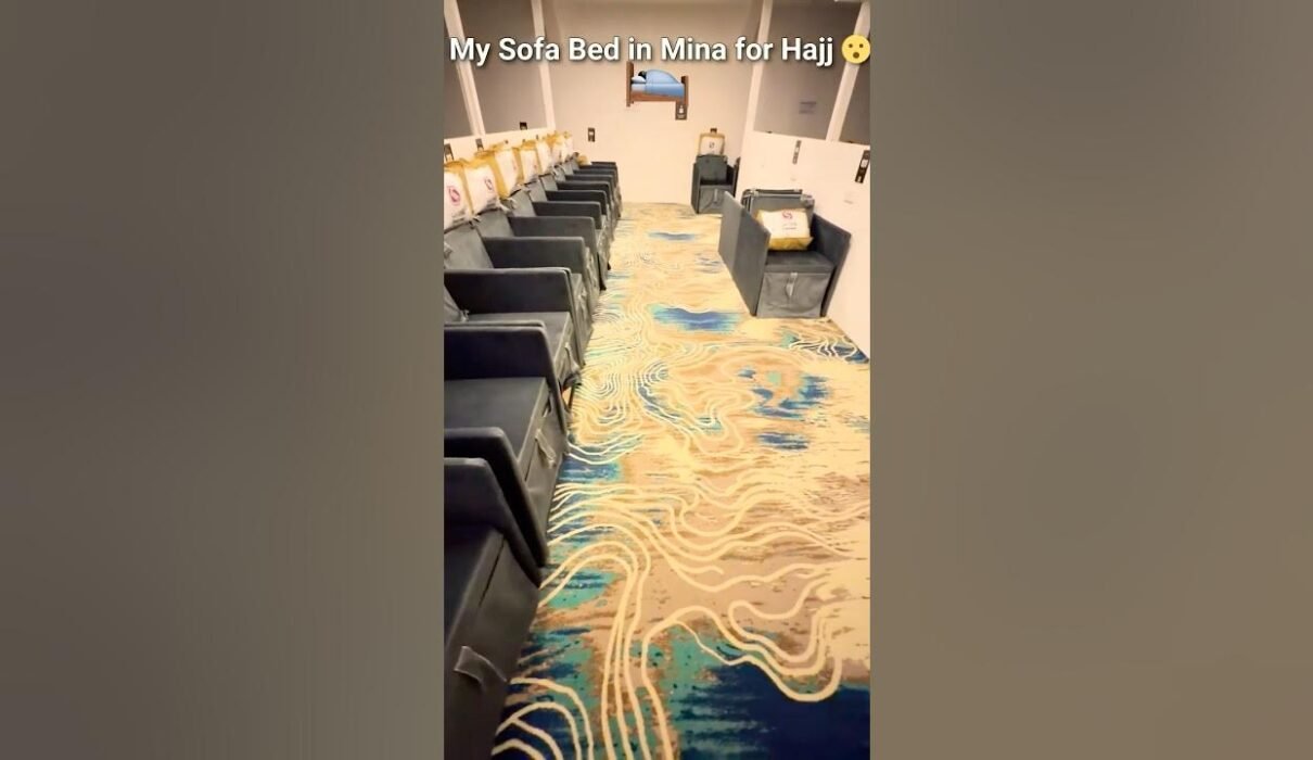 Inside a Mina tent during Hajj 2026 with rows of sofa beds for pilgrims